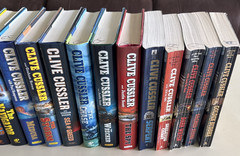 Clive Cussler Assorted Series – Lot 24 (19) Hard Cover and (5) Paperback