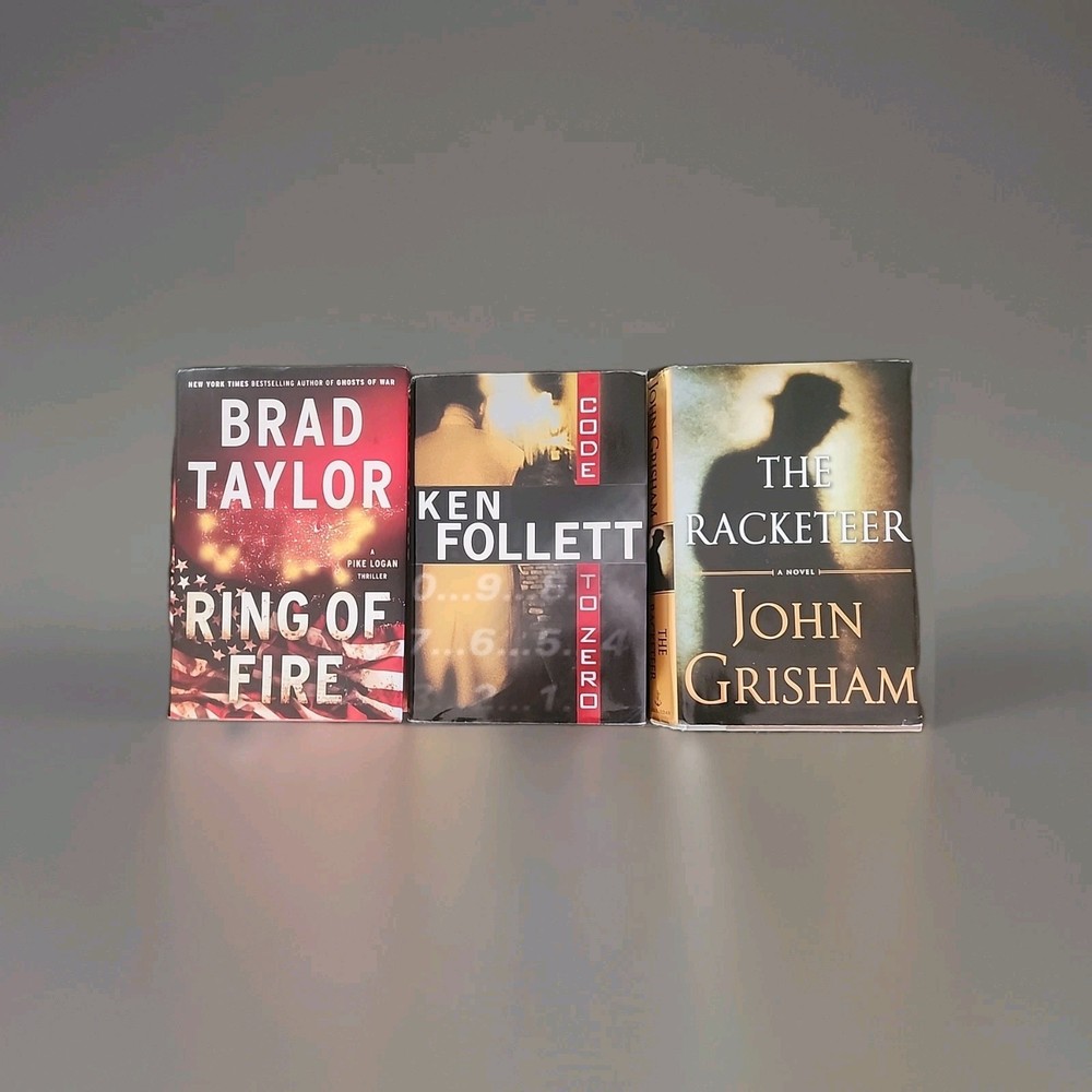 Lot of 3 Brad Taylor, Ken Follett and John Grisham hardcover books As Shown