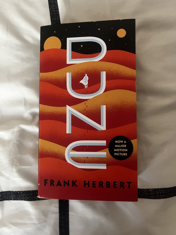 Dune by Frank Herbert. Paperback, like new. Broken in spine.