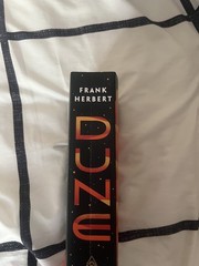 Dune by Frank Herbert. Paperback, like new. Broken in spine.