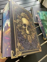 The limited edition hardcover novel Manacled (printed on three sides) collec